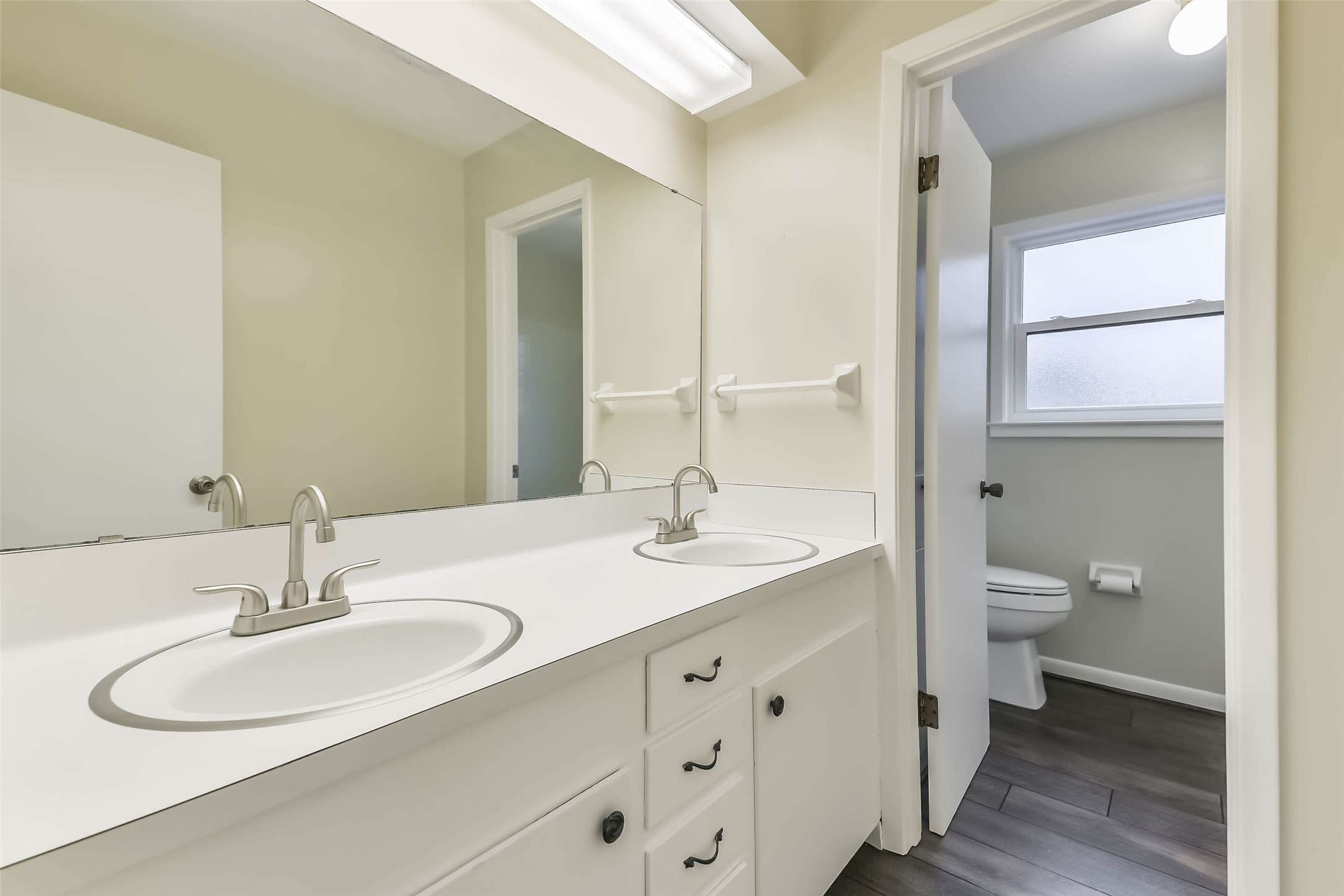 1210 Timber Lane Rosenberg, TX 77471 - Photo 35 of 48 a bathroom with a granite countertop sink a toilet and a large mirror