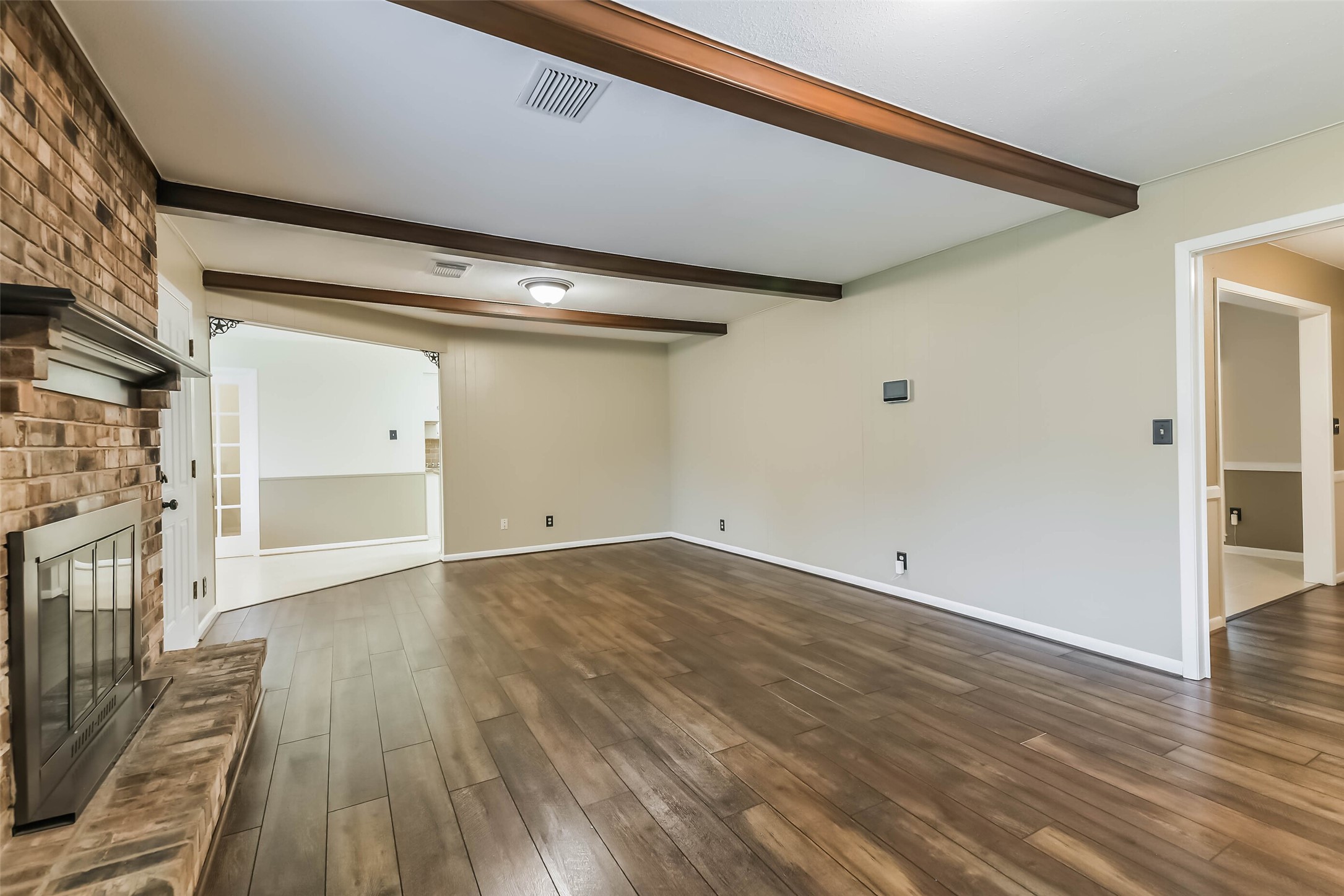 1210 Timber Lane Rosenberg, TX 77471 - Photo 5 of 48 a view of a room with wooden floor and a fireplace