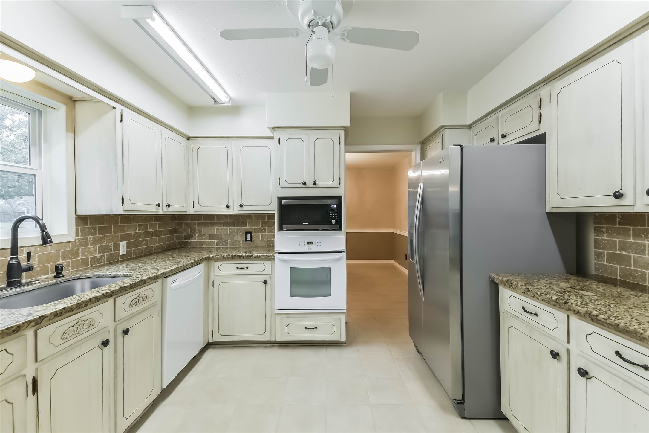 1210 Timber Lane Rosenberg, TX 77471 - Photo 10 of 48 a kitchen with stainless steel appliances a refrigerator sink and cabinets