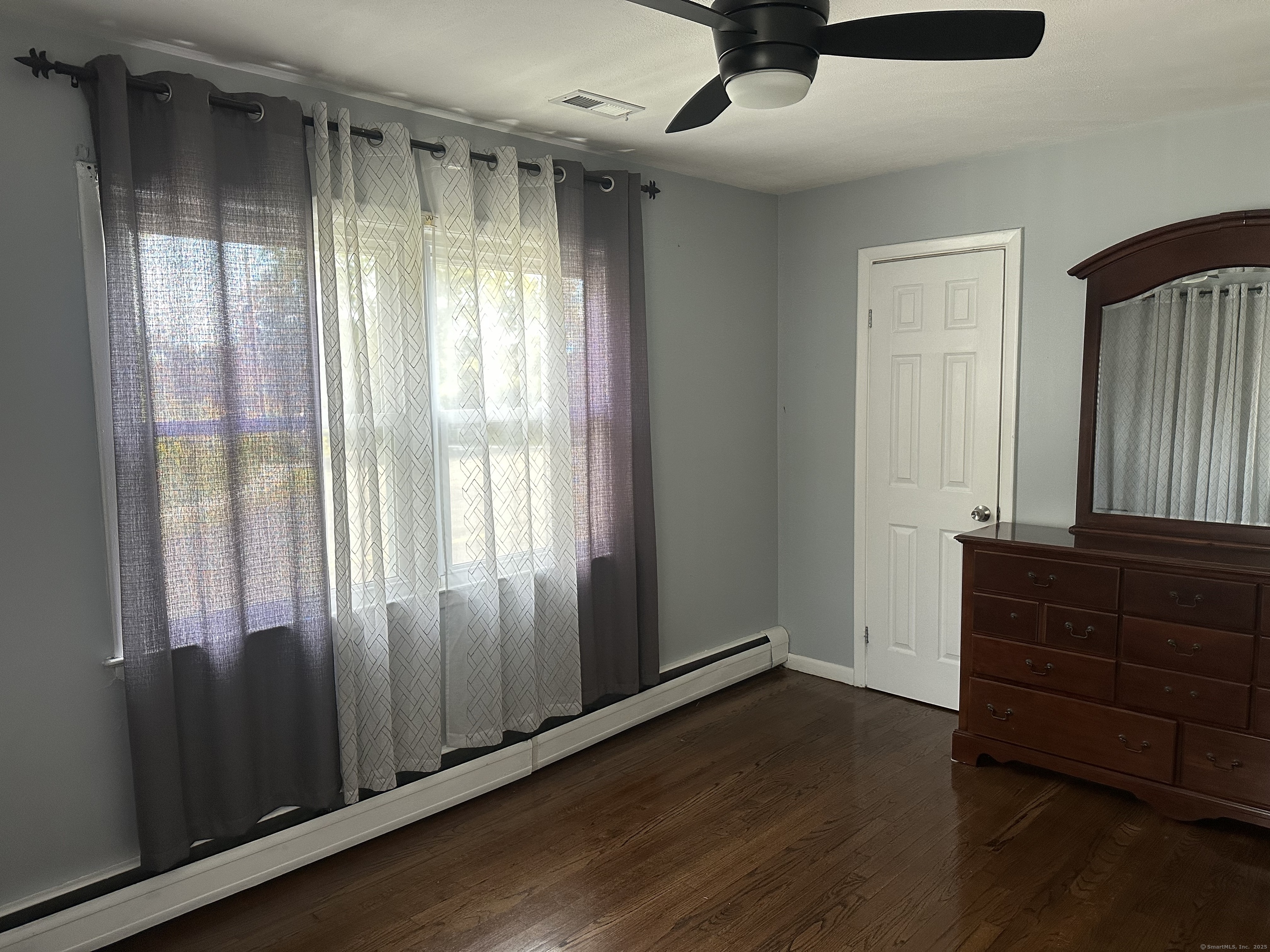 196 Monroe Street Milford, CT 06460 - Photo 11 of 31 an empty room with wooden floor and windows