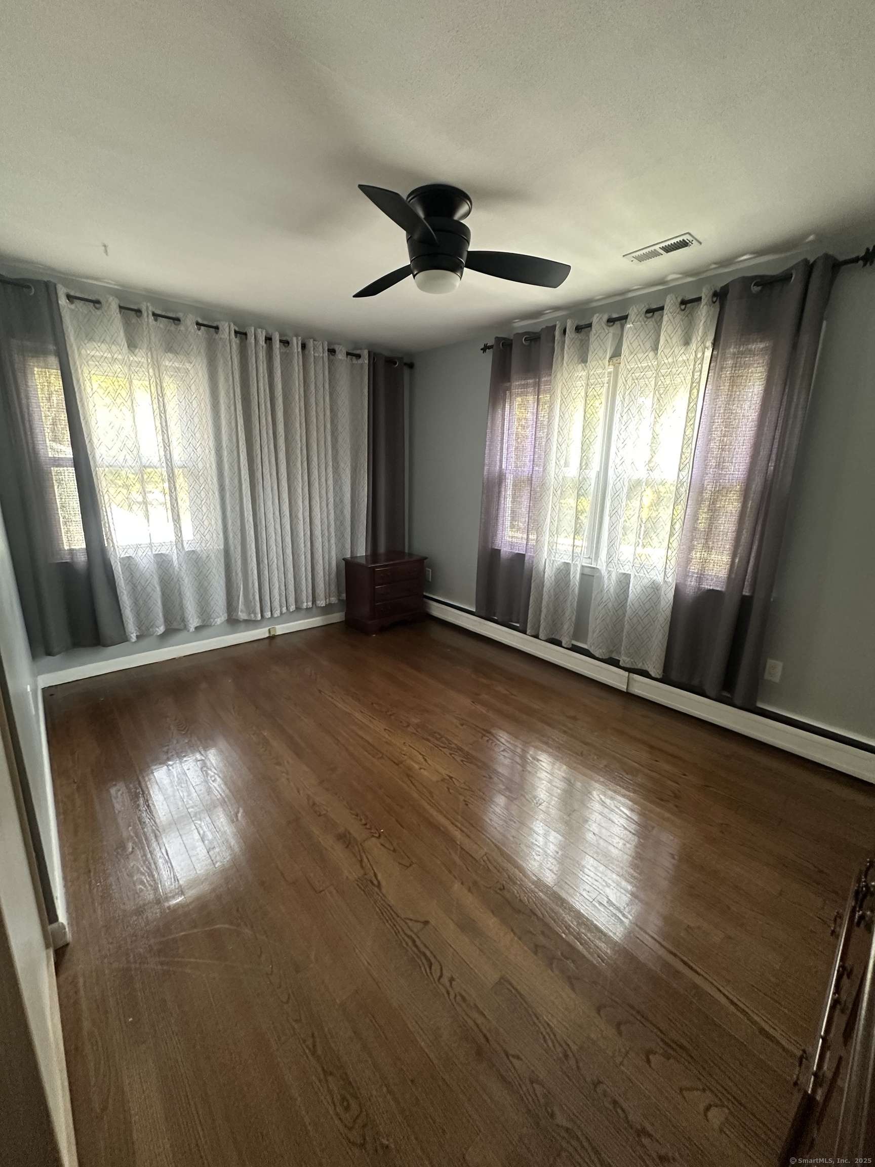 196 Monroe Street Milford, CT 06460 - Photo 12 of 31 wooden floor in an empty room with a window