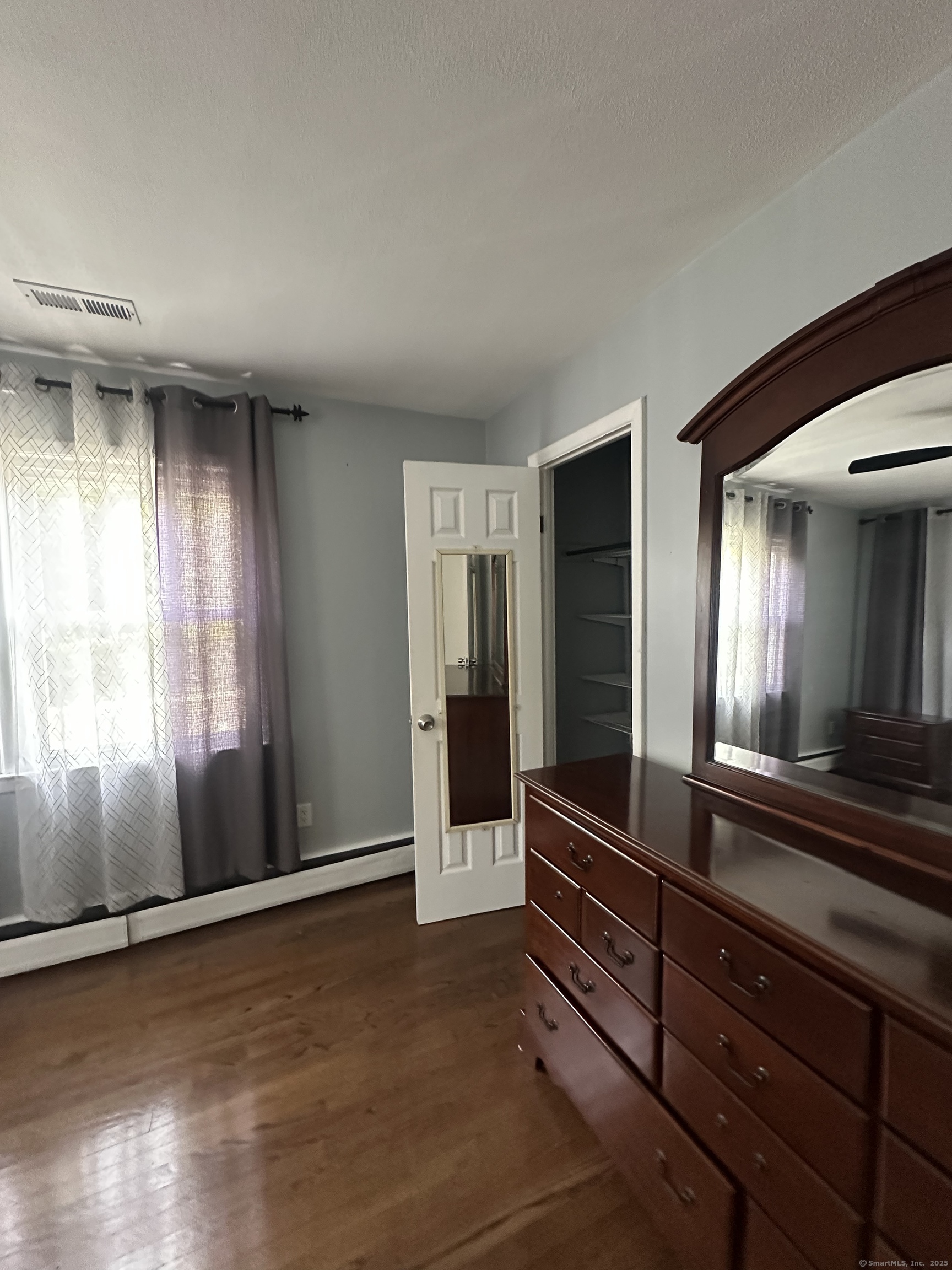 196 Monroe Street Milford, CT 06460 - Photo 13 of 31 an empty room with wooden floor and windows