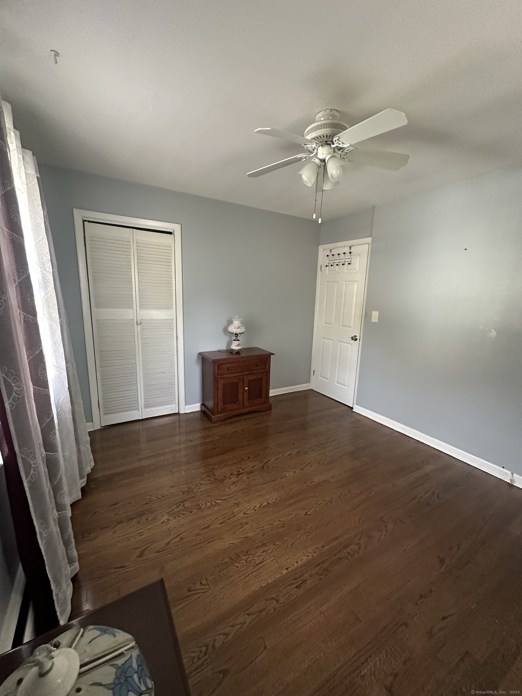 196 Monroe Street Milford, CT 06460 - Photo 14 of 31 a view of empty room with wooden floor and fan