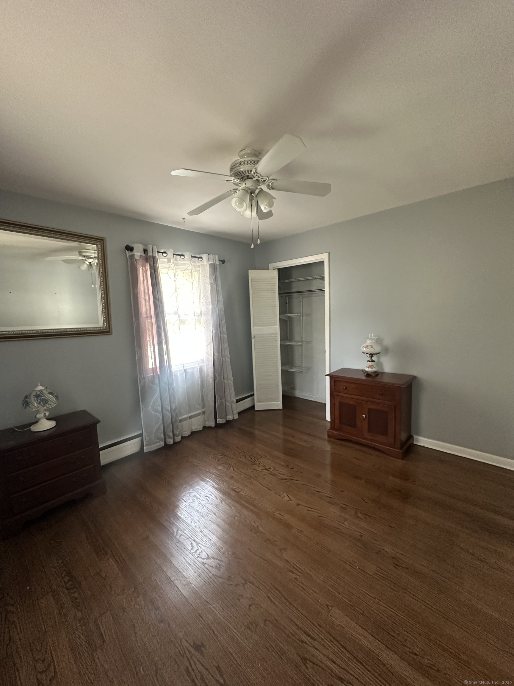 196 Monroe Street Milford, CT 06460 - Photo 15 of 31 a view of empty room with wooden floor and fan