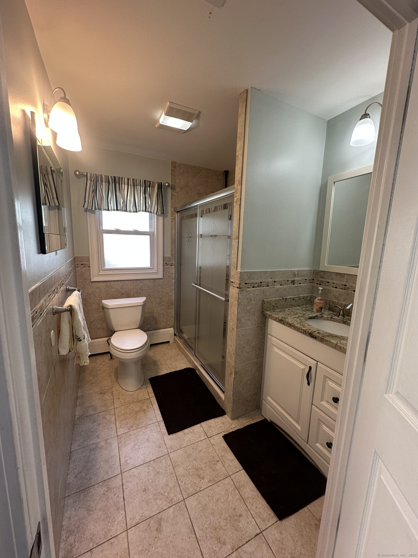 196 Monroe Street Milford, CT 06460 - Photo 17 of 31 a bathroom with a sink a toilet and mirror