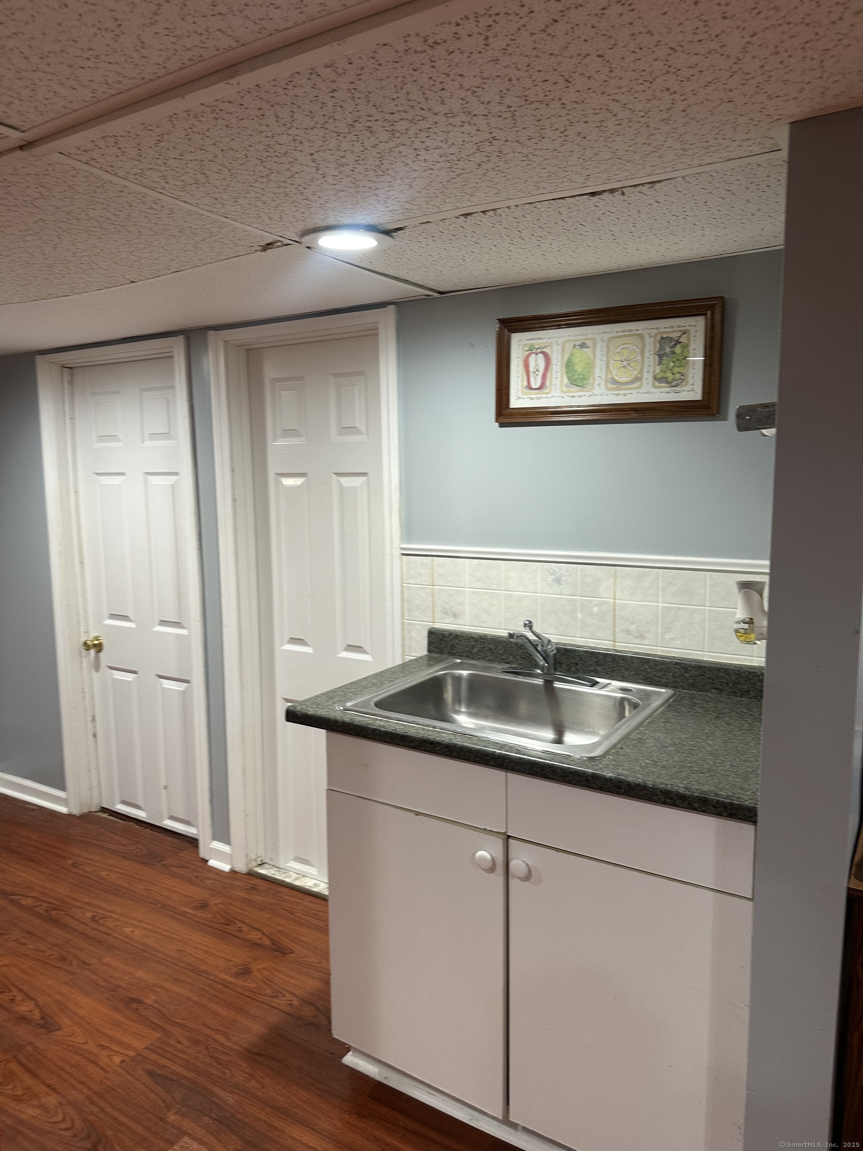 196 Monroe Street Milford, CT 06460 - Photo 18 of 31 a bathroom with a granite countertop sink and a mirror