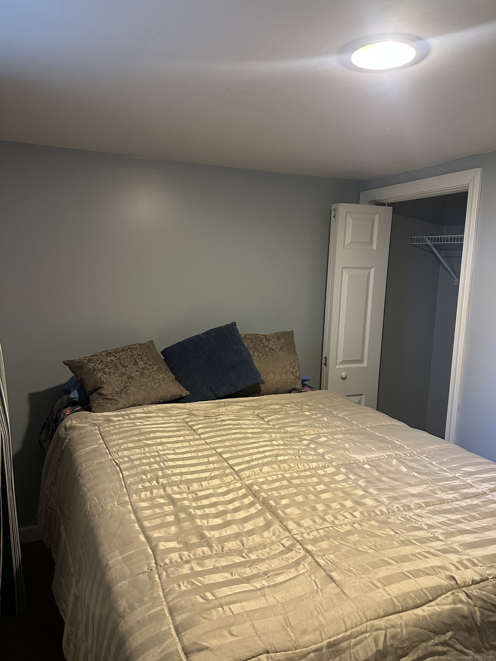 196 Monroe Street Milford, CT 06460 - Photo 28 of 31 a bed sitting in a bedroom and closet