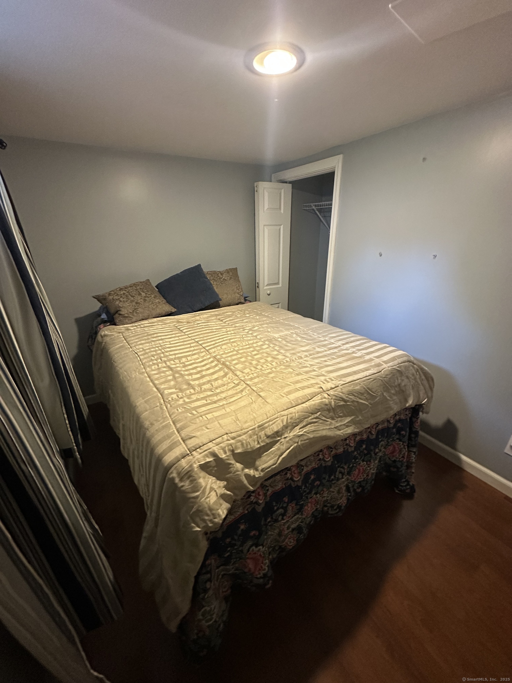 196 Monroe Street Milford, CT 06460 - Photo 30 of 31 a bed sitting in a bedroom next to a window