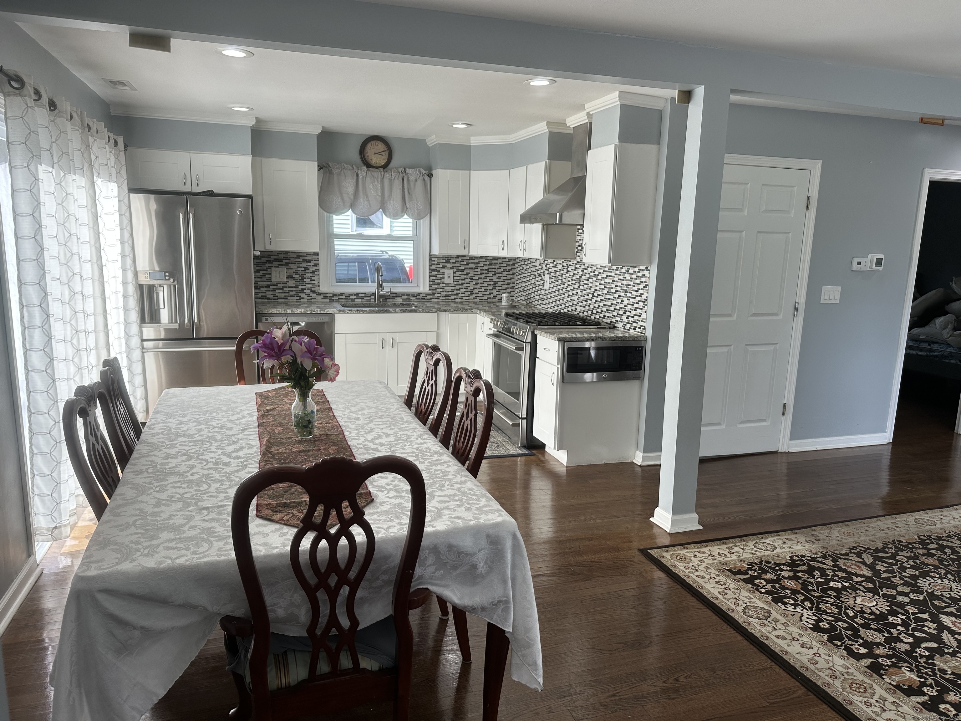 196 Monroe Street Milford, CT 06460 - Photo 4 of 31 a kitchen with granite countertop white cabinets and stainless steel appliances