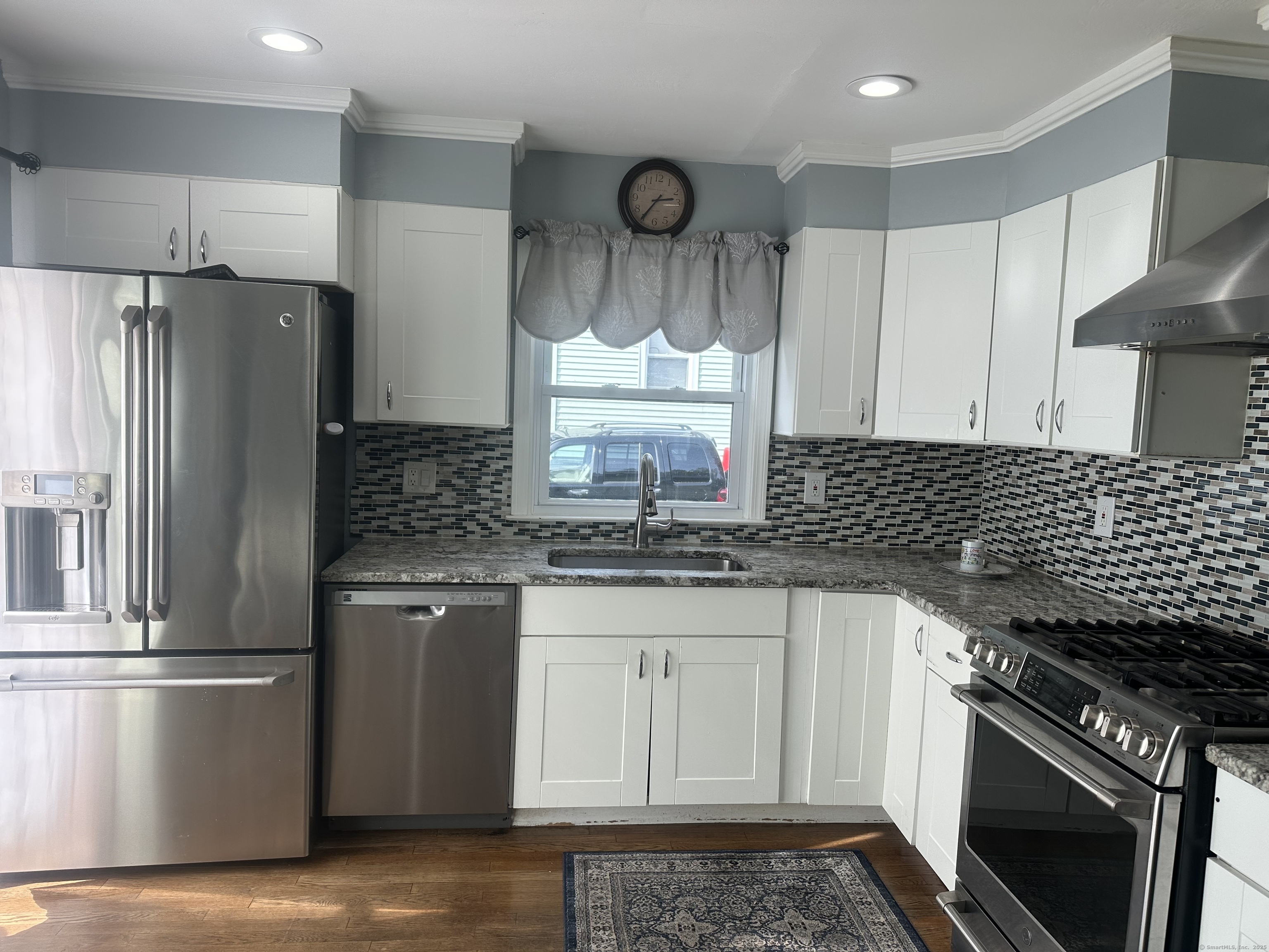 196 Monroe Street Milford, CT 06460 - Photo 6 of 31 a kitchen with granite countertop a stove sink and refrigerator