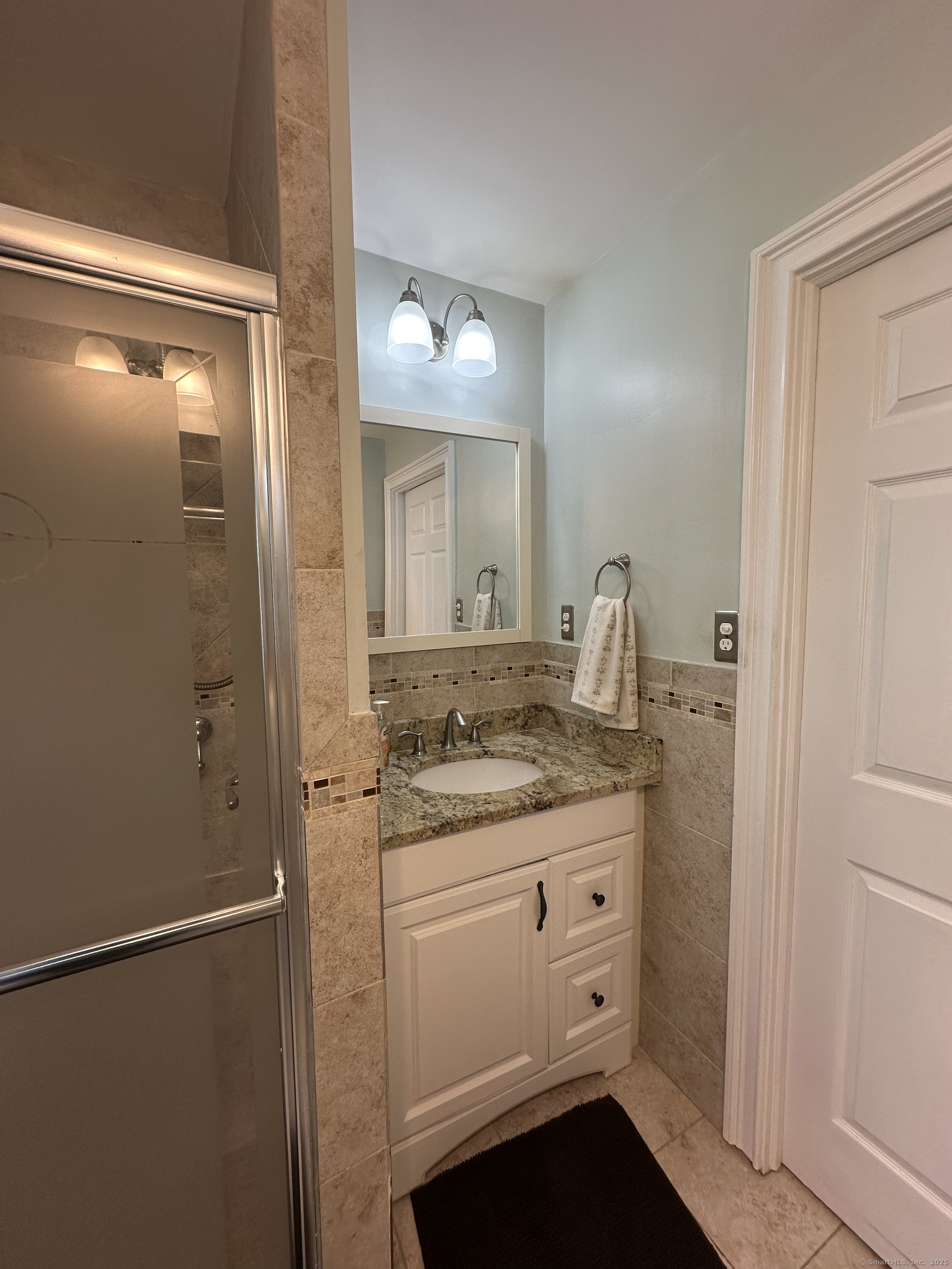 196 Monroe Street Milford, CT 06460 - Photo 10 of 31 a bathroom with a granite countertop sink and a mirror