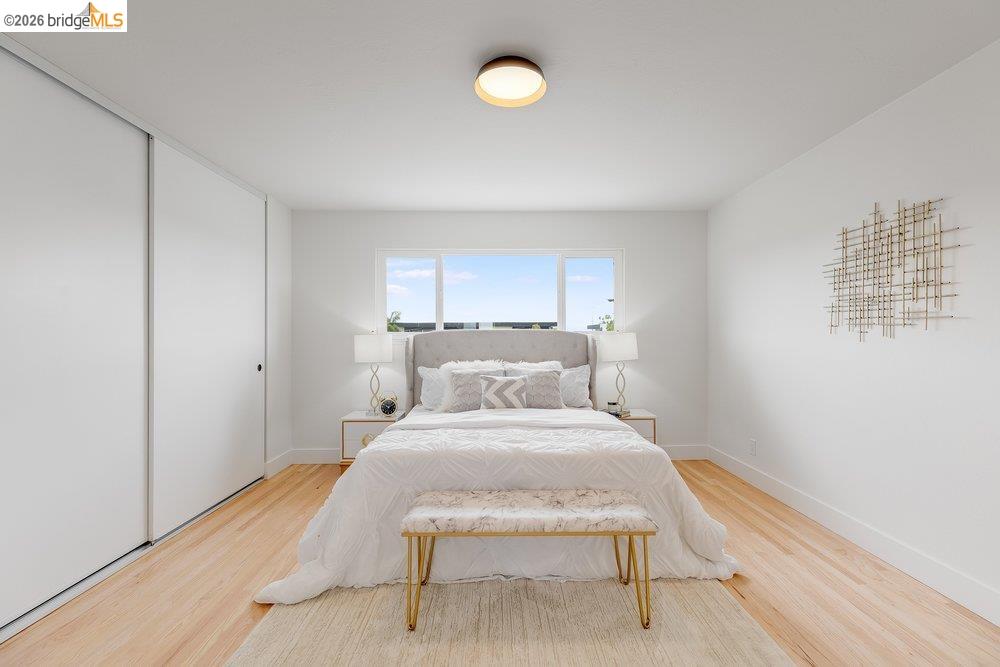 1298 Ribbon Street Foster City, CA 94404 - Photo 60 of 86 Light-filled room featuring a rectangular window, light wood-finish flooring, white walls, and a ceiling-mounted light fixture