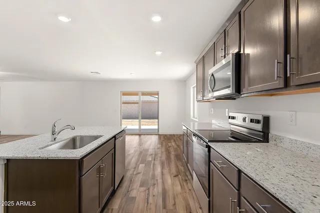 a kitchen with sink cabinets and stove