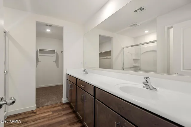 a bathroom with a double vanity sink and mirror