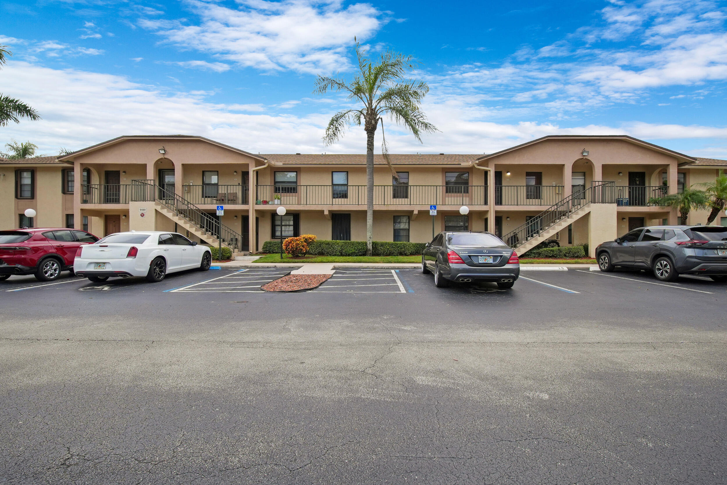 9480 Boca Cove Circle, Unit 415 Boca Raton, FL 33428 - Photo 1 of 25 a couple of cars parked in front of a building