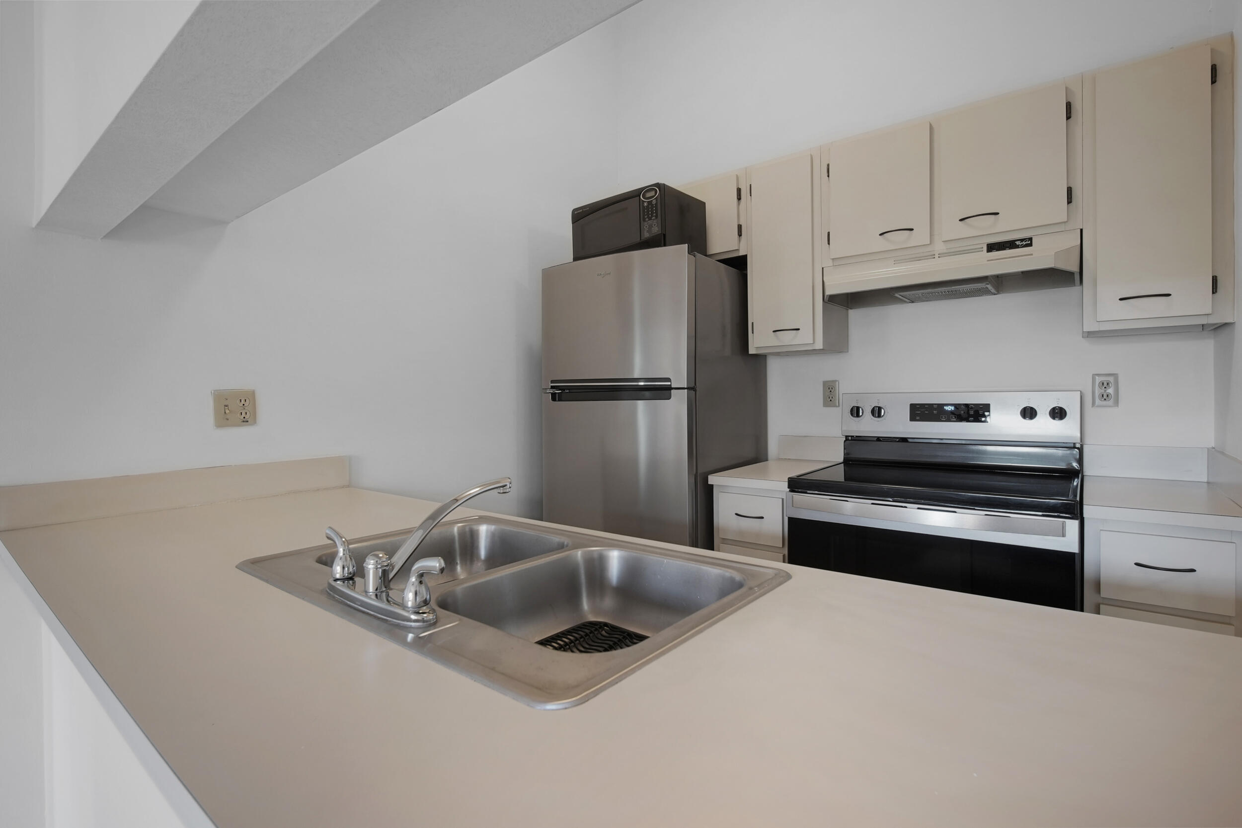 9480 Boca Cove Circle, Unit 415 Boca Raton, FL 33428 - Photo 12 of 25 a kitchen with stainless steel appliances granite countertop a refrigerator and a sink