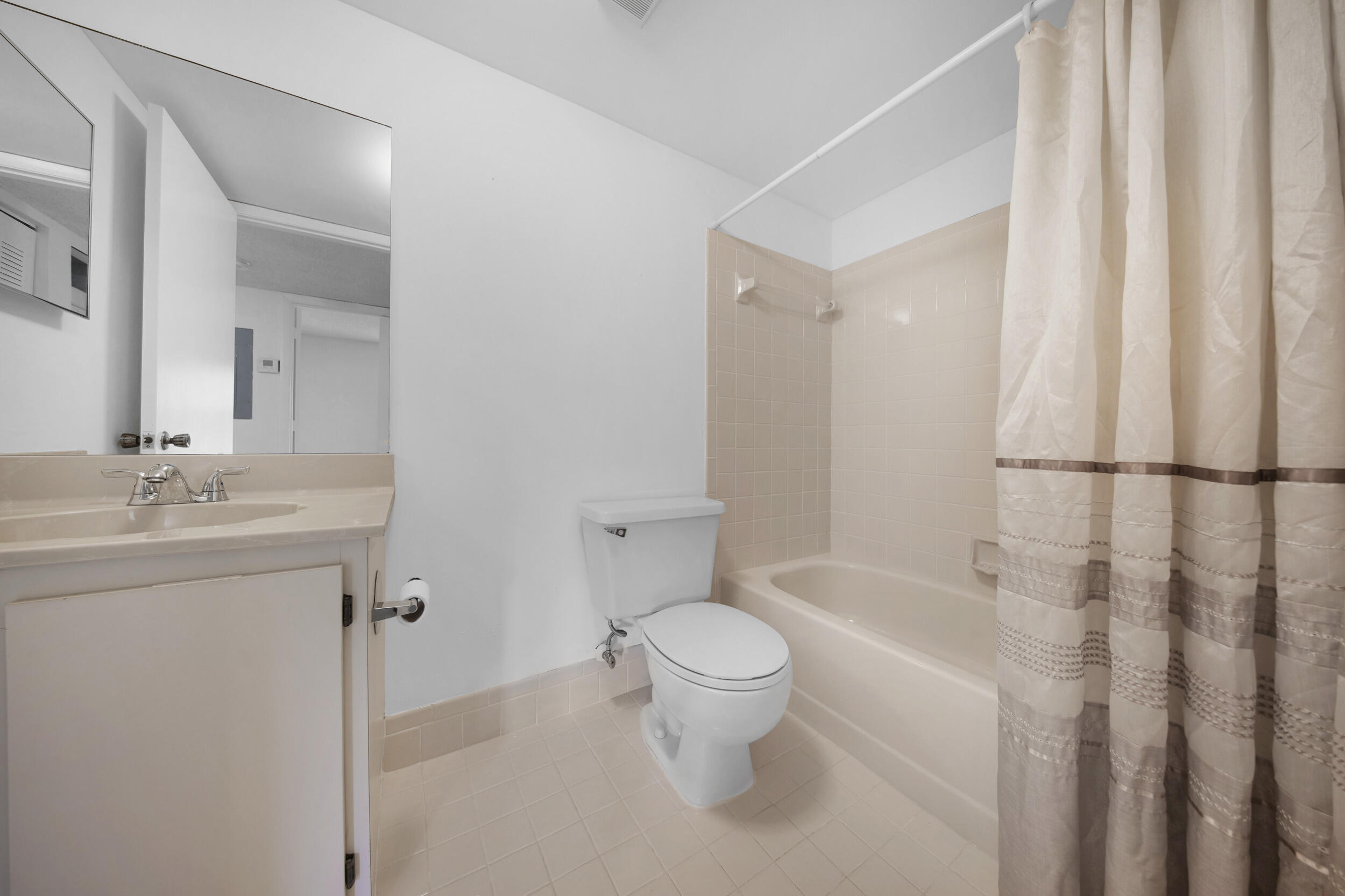 9480 Boca Cove Circle, Unit 415 Boca Raton, FL 33428 - Photo 20 of 25 a bathroom with a granite countertop sink a toilet and shower