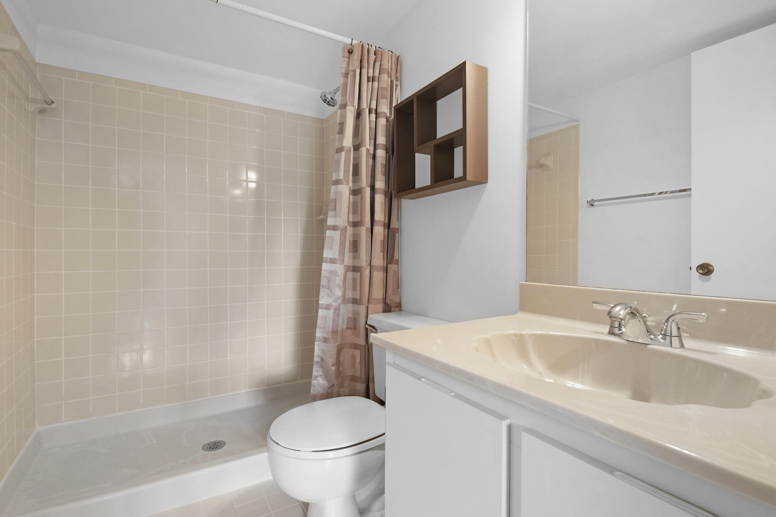 9480 Boca Cove Circle, Unit 415 Boca Raton, FL 33428 - Photo 21 of 25 a bathroom with a sink toilet and shower