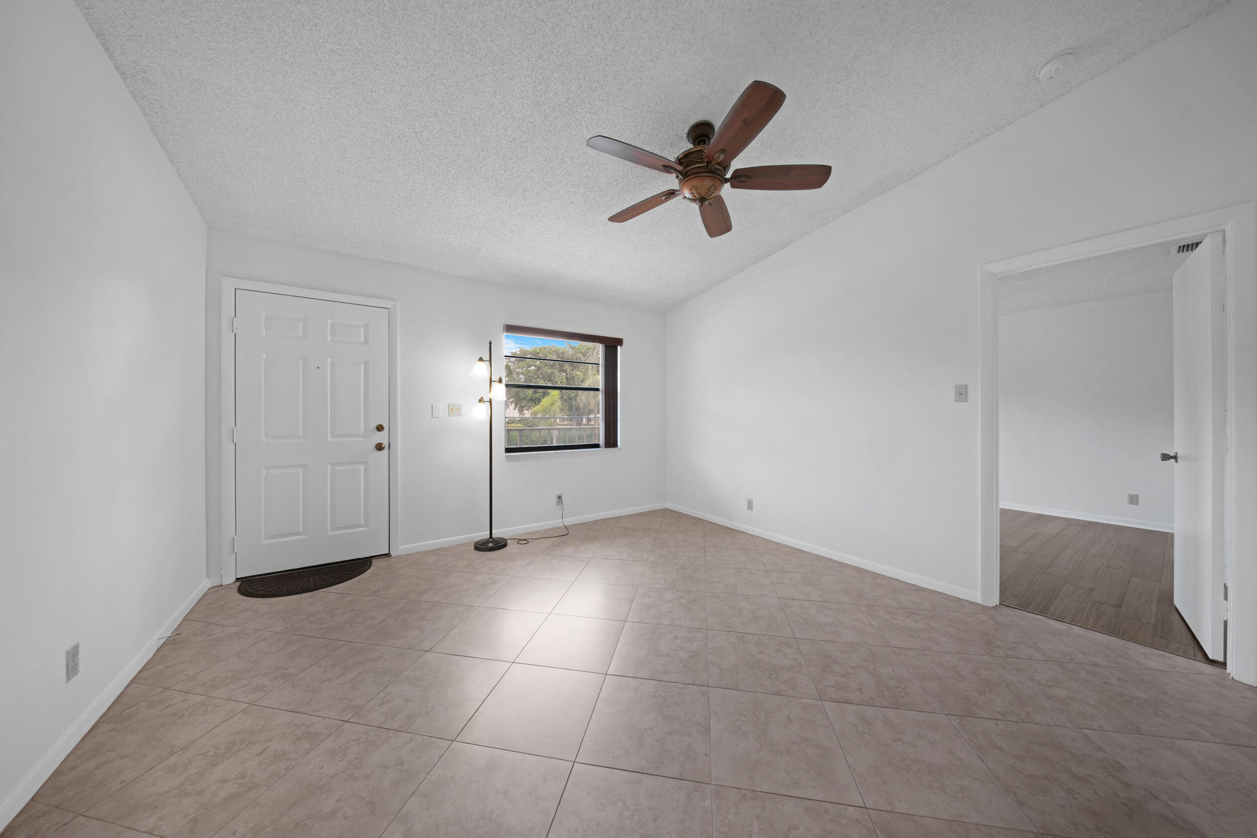 9480 Boca Cove Circle, Unit 415 Boca Raton, FL 33428 - Photo 6 of 25 a view of a livingroom with a ceiling fan and window