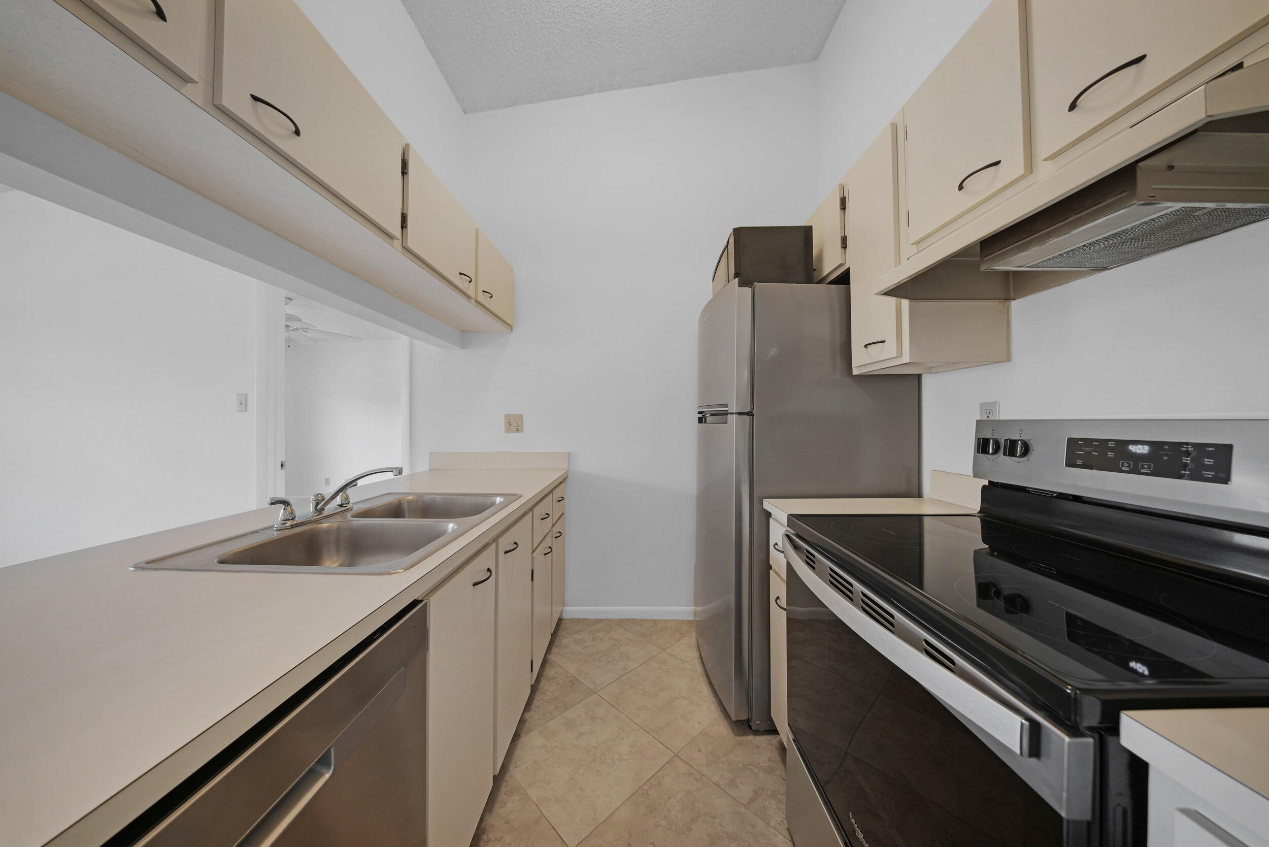 9480 Boca Cove Circle, Unit 415 Boca Raton, FL 33428 - Photo 10 of 25 a kitchen with a sink and stainless steel appliances