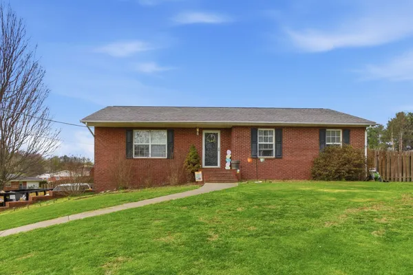 a front view of house with yard and green space