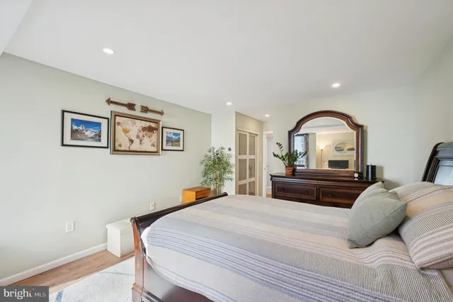 a bedroom with a large bed and a mirror