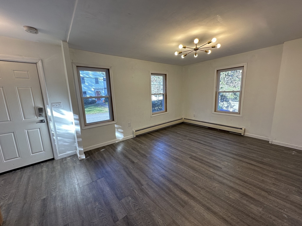 8 Pike Street Hopkinton, MA 01748 - Photo 6 of 34 an empty room with wooden floor and window