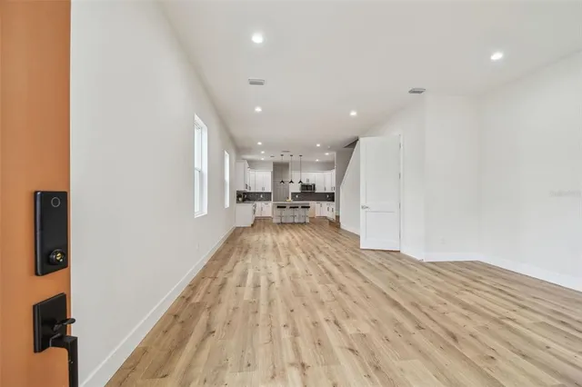 a view of kitchen with wooden floor and electronic appliances