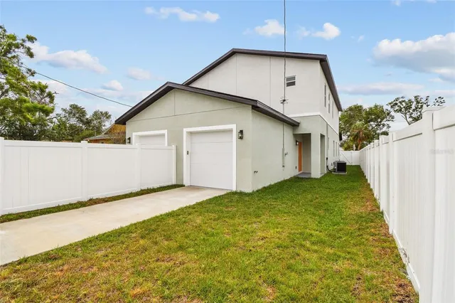 a view of an house with backyard space and balcony