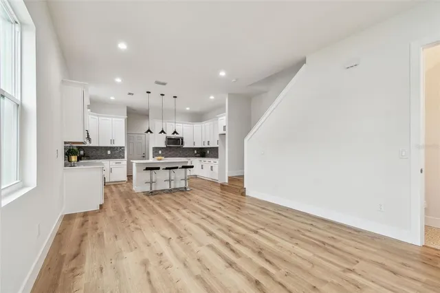 a kitchen with stainless steel appliances kitchen island granite countertop a refrigerator and a stove top oven