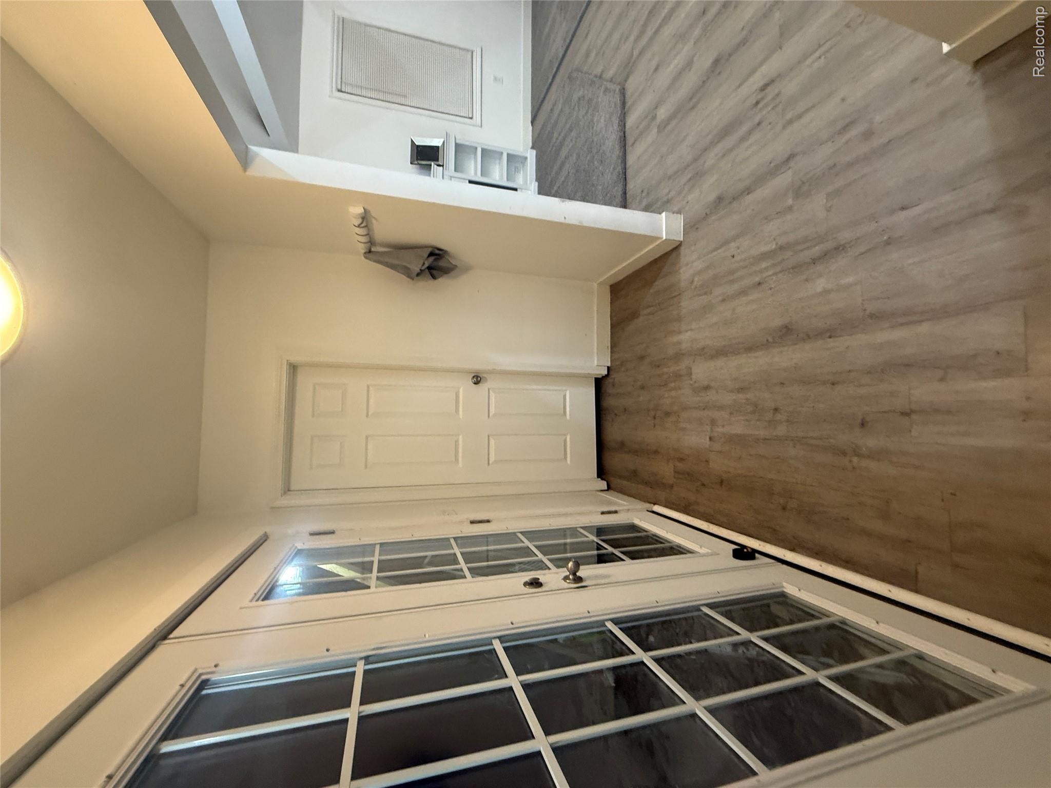 44862 Willis Road Belleville, MI 48111 - Photo 11 of 14 Hall with dark wood-style floors and french doors