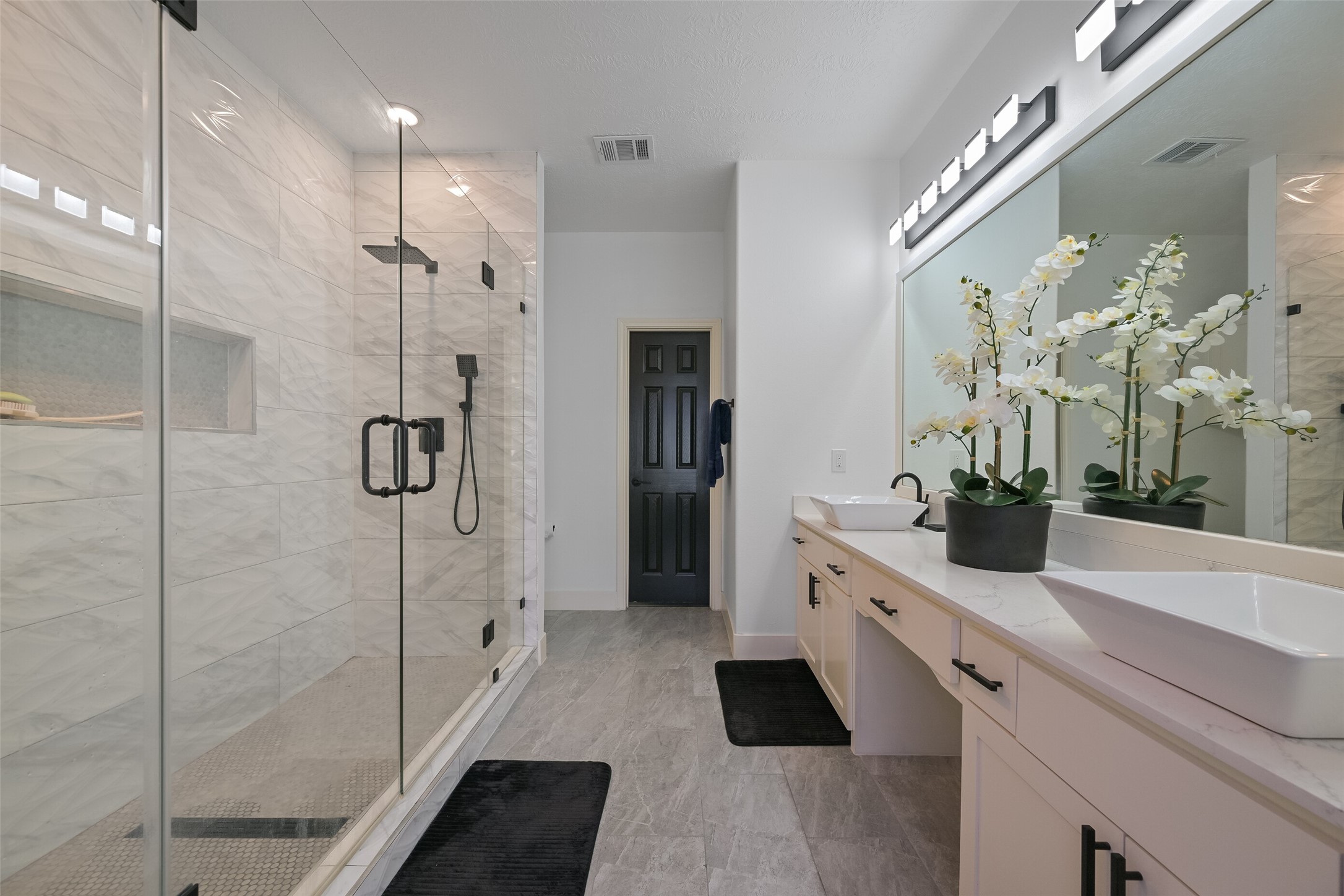 2007 Que Manor Drive Houston, TX 77090 - Photo 20 of 29 a bathroom with a double vanity sink a large mirror a shower and glass door