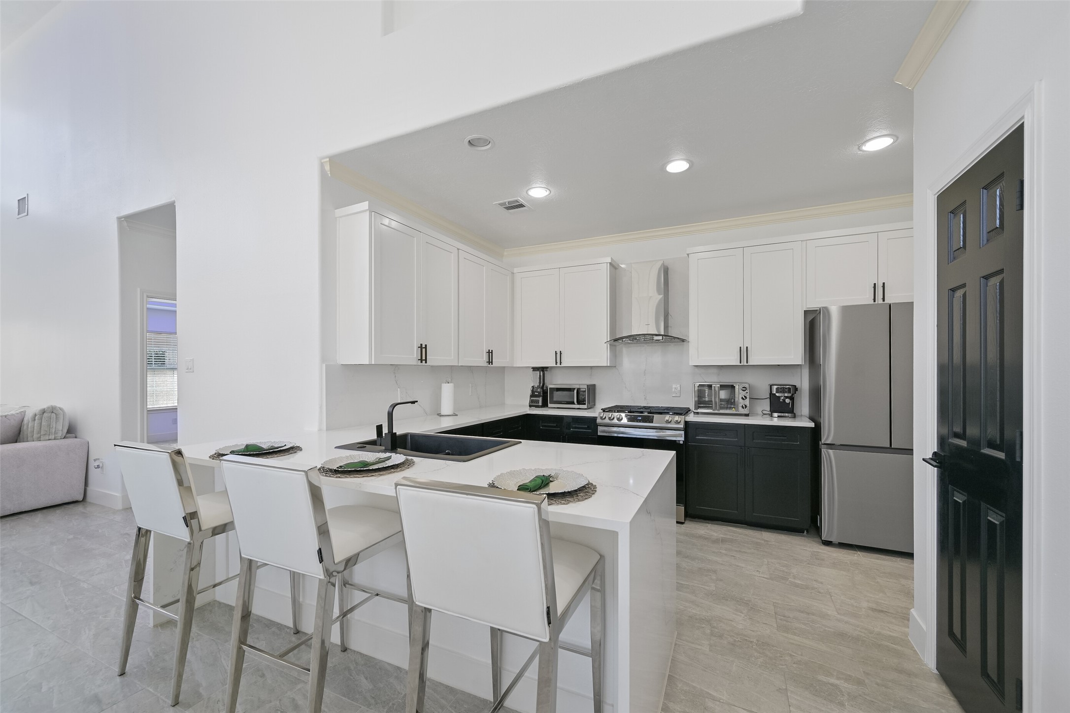 2007 Que Manor Drive Houston, TX 77090 - Photo 6 of 29 a kitchen that has a refrigerator a stove a sink and chairs