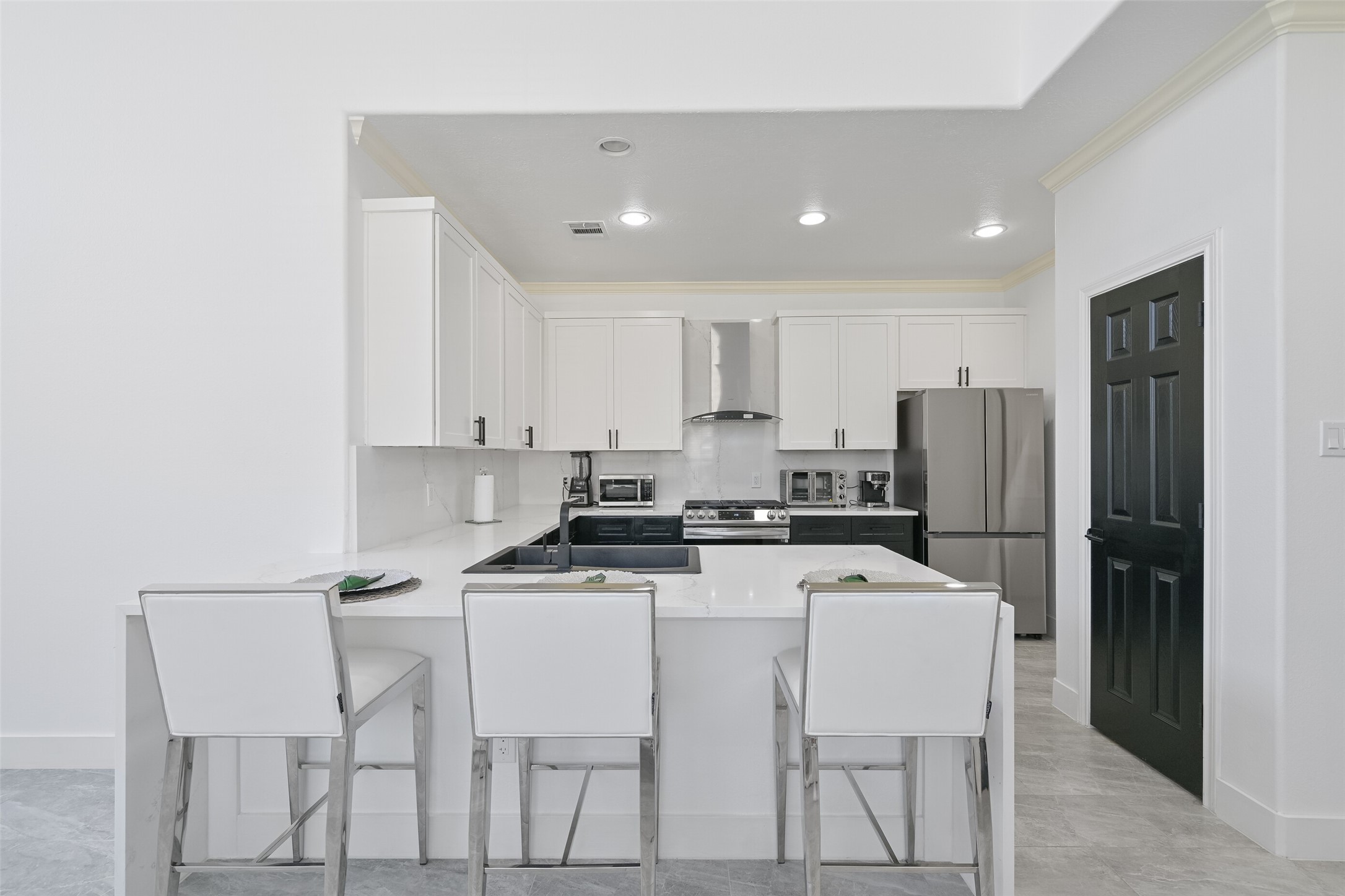 2007 Que Manor Drive Houston, TX 77090 - Photo 7 of 29 a kitchen that has a dining table and stainless steel appliances
