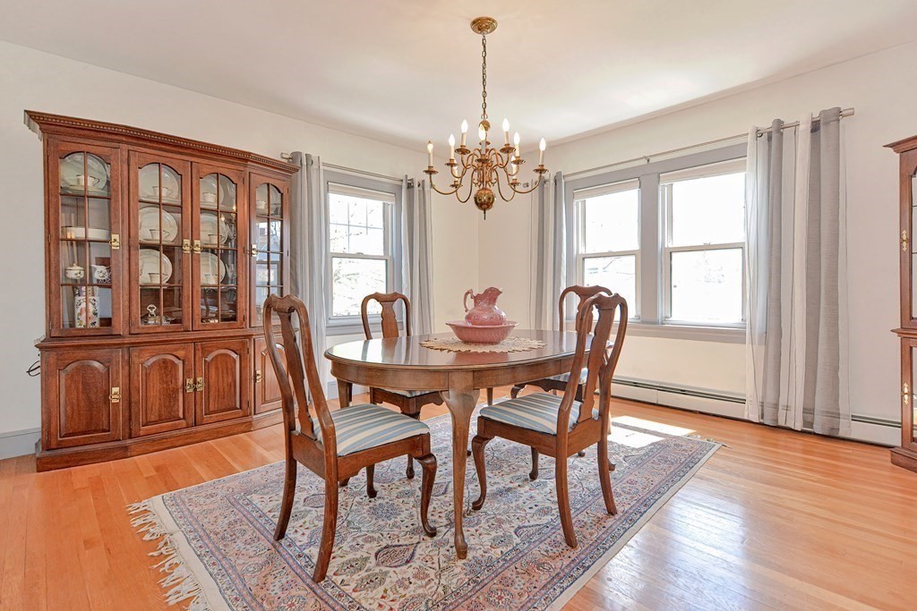 18 1/2 Whitney Street Milford, MA 01757 - Photo 13 of 34 a dining room with furniture a chandelier and wooden floor
