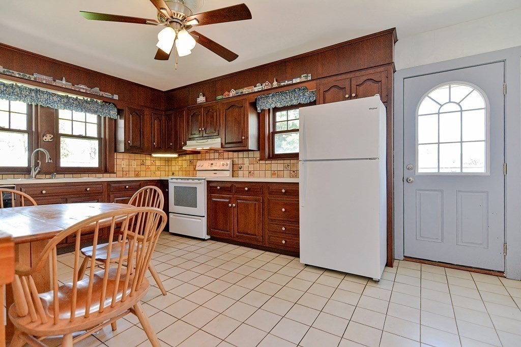 18 1/2 Whitney Street Milford, MA 01757 - Photo 16 of 34 a kitchen with stainless steel appliances granite countertop a sink a stove a refrigerator cabinets and dining table