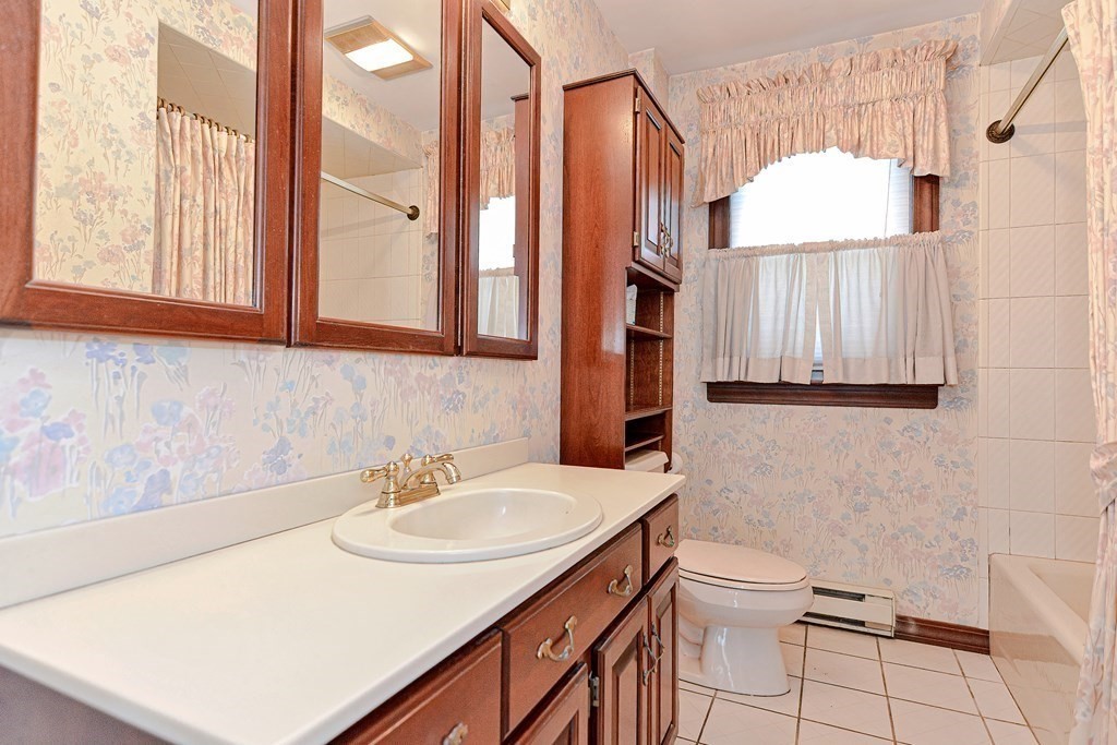 18 1/2 Whitney Street Milford, MA 01757 - Photo 20 of 34 a bathroom with a sink vanity and a mirror