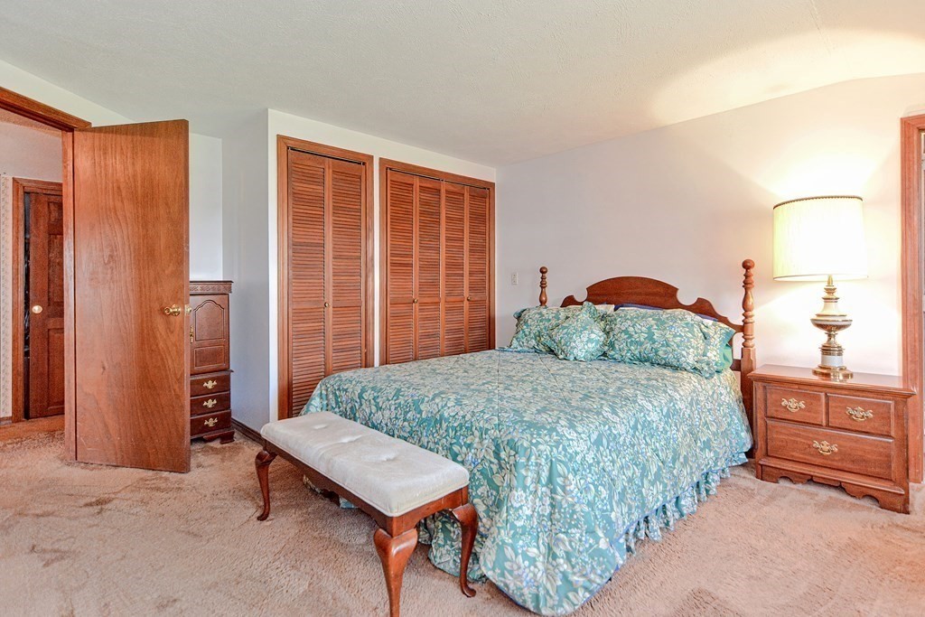 18 1/2 Whitney Street Milford, MA 01757 - Photo 26 of 34 a bedroom with a bed and large windows
