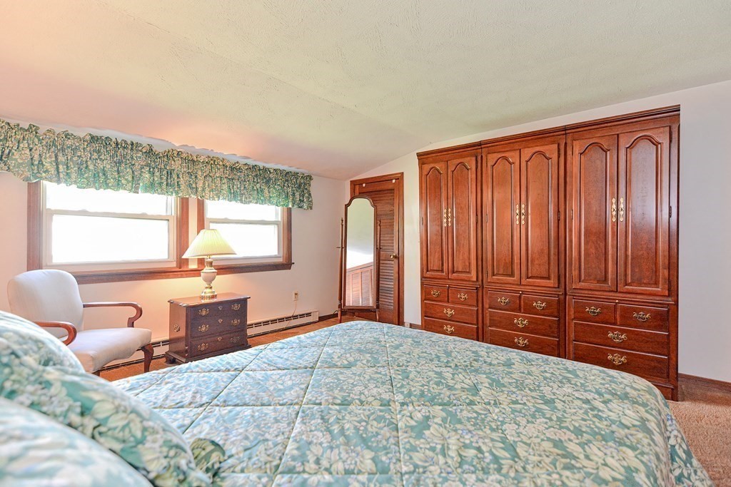 18 1/2 Whitney Street Milford, MA 01757 - Photo 27 of 34 a bedroom with a large bed and two windows