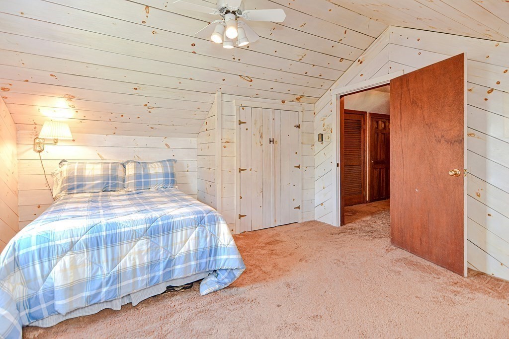 18 1/2 Whitney Street Milford, MA 01757 - Photo 28 of 34 a bedroom with a bed and a chandelier