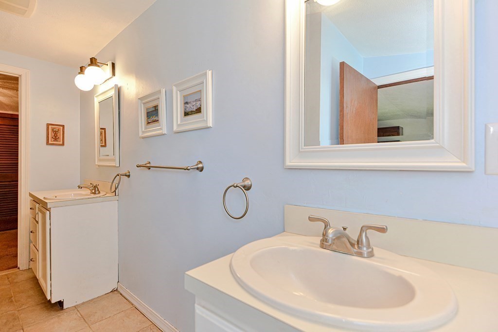 18 1/2 Whitney Street Milford, MA 01757 - Photo 30 of 34 a bathroom with a sink and a mirror