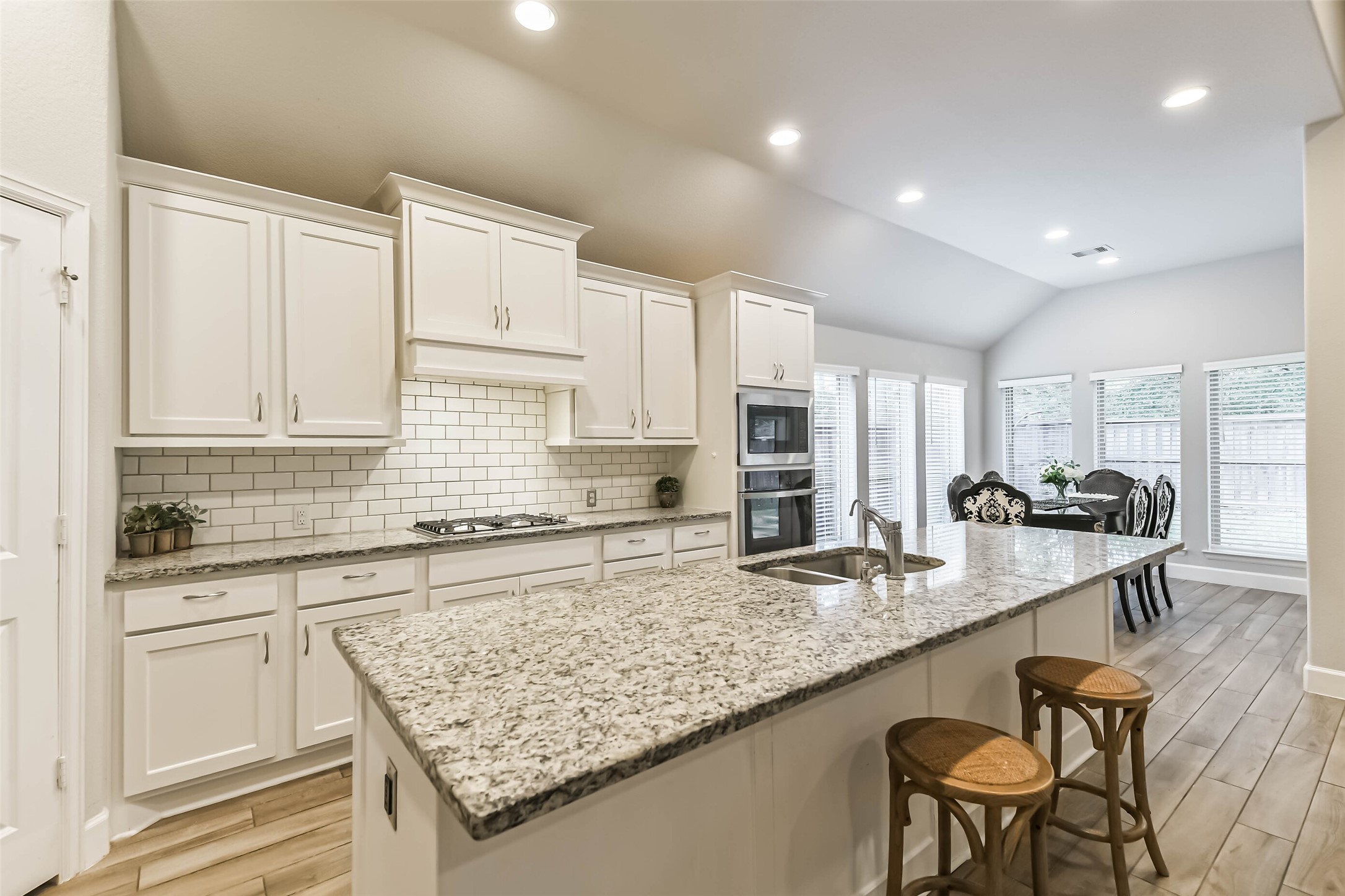 8132 Tyrell Hgts Road Magnolia, TX 77354 - Photo 11 of 40 Sleek granite countertops and abundant cabinetry, offering style and space for culinary adventures.