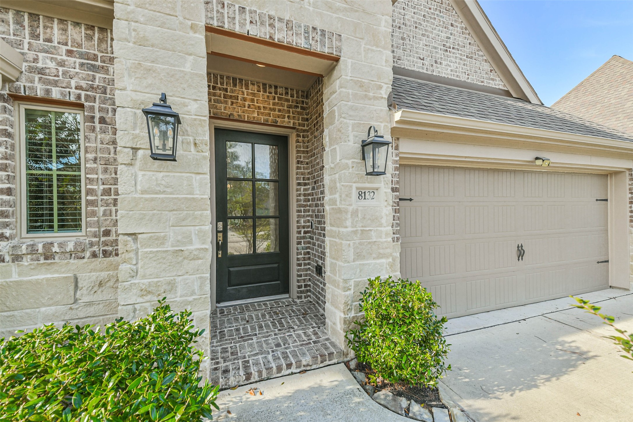 8132 Tyrell Hgts Road Magnolia, TX 77354 - Photo 2 of 40 Stunning brick and stone elevation, exuding timeless elegance and inviting warmth.