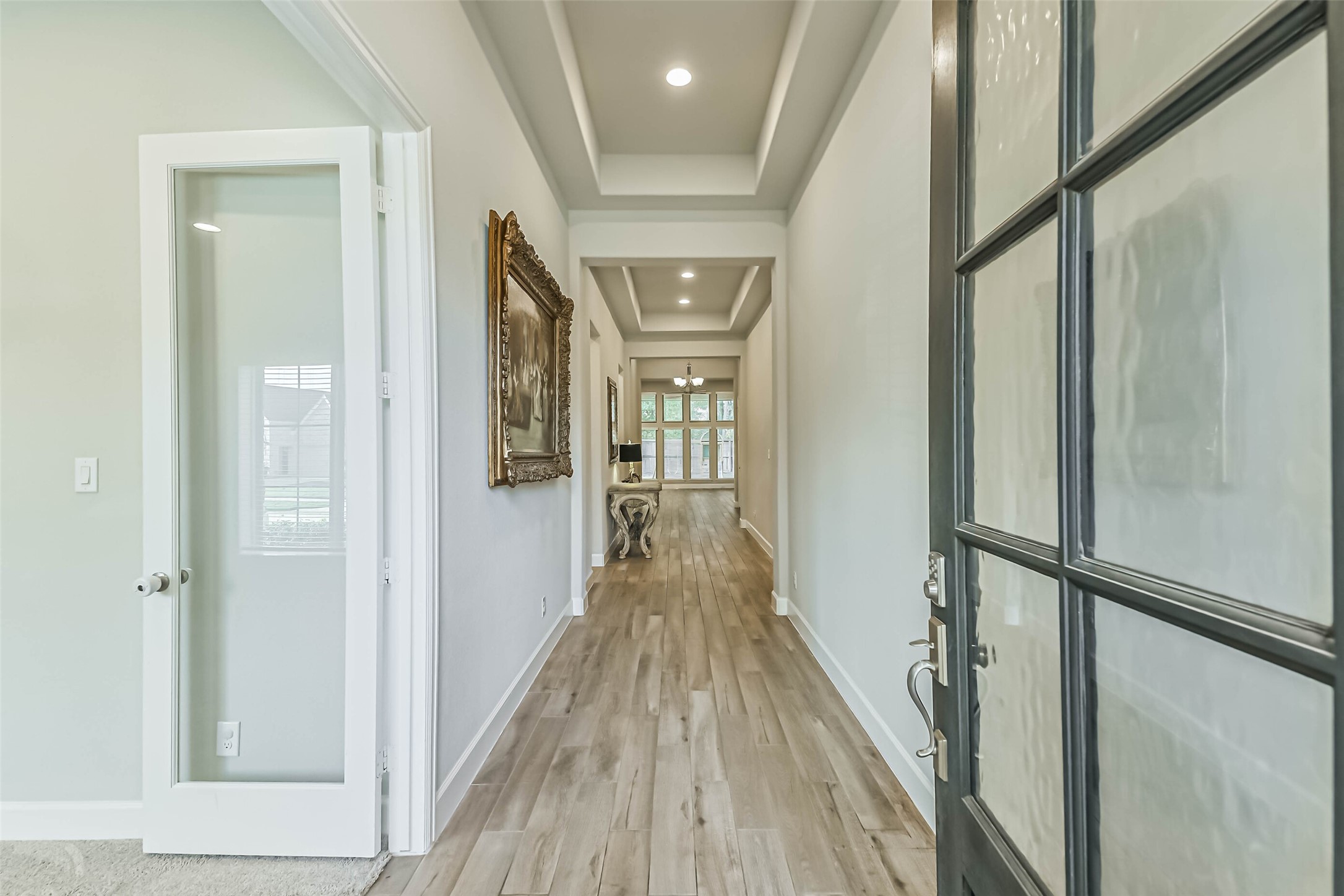 8132 Tyrell Hgts Road Magnolia, TX 77354 - Photo 4 of 40 Step into an inviting entrance with an impressive 12-foot ceiling, setting the tone for elegance throughout the home.