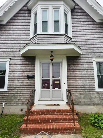 a view of brick house with large windows