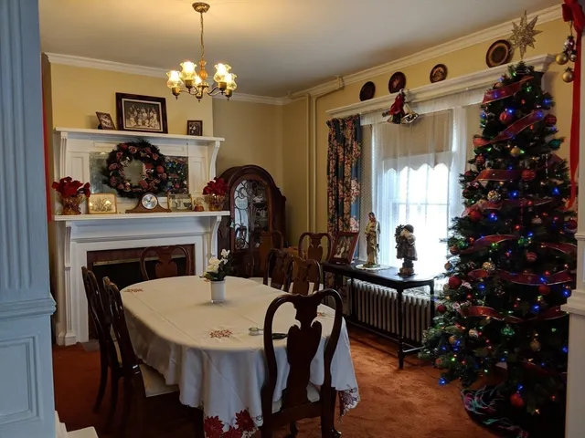 a kitchen with a table chairs and a living room