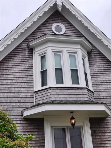 a view of building with front door and deck