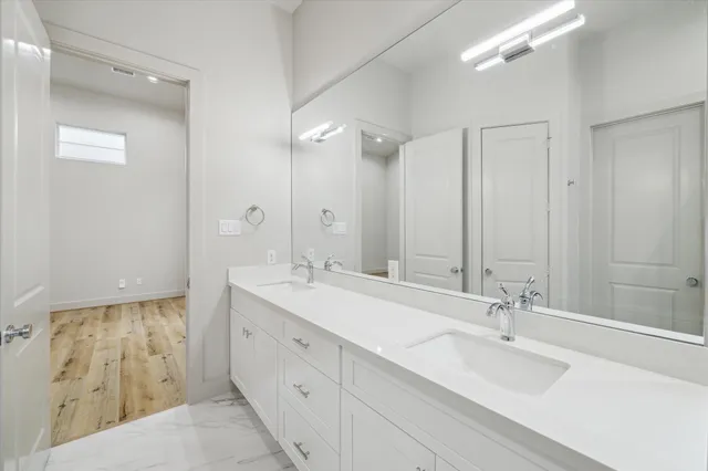 a bathroom with a double vanity sink mirror and double