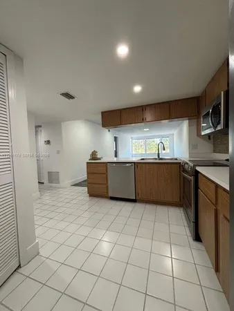 a kitchen with stainless steel appliances granite countertop a sink and cabinets