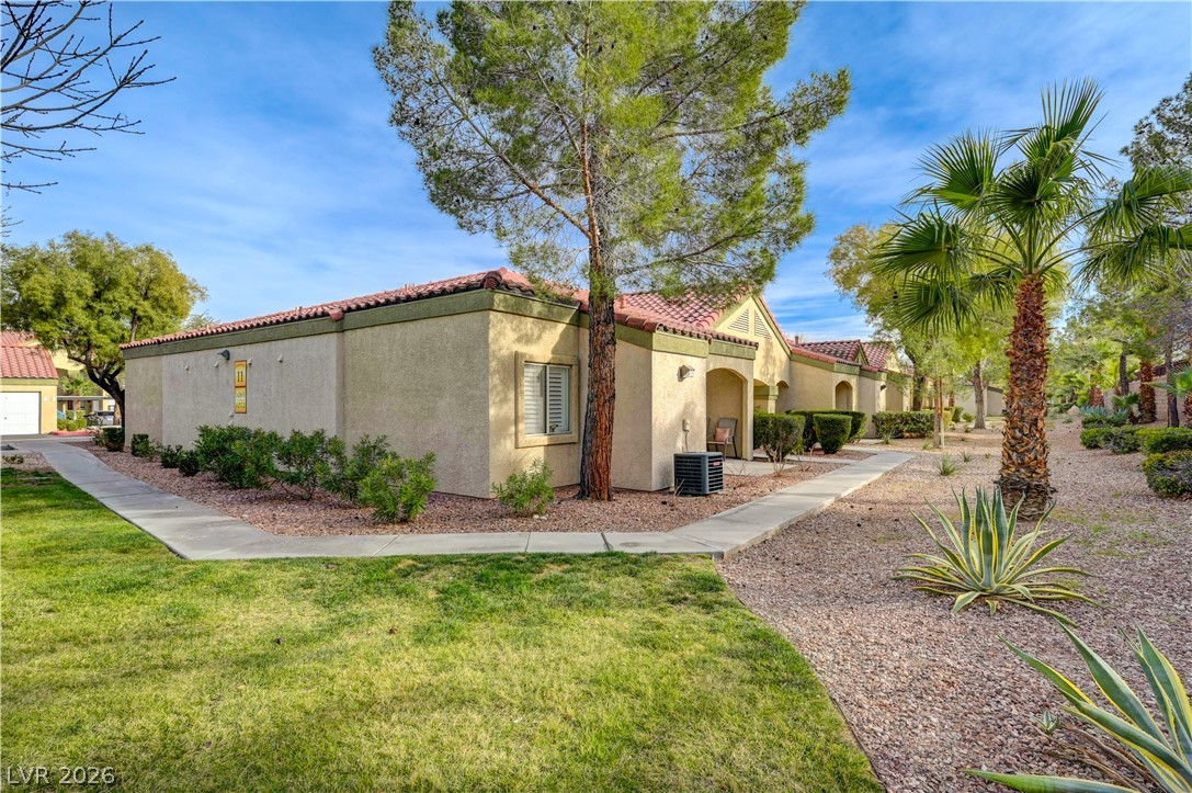 7885 West Flamingo Road, Unit 1071 Las Vegas, NV 89147 - Photo 3 of 28 Mature trees and lush landscaping adorn this charming residence with a private entry.